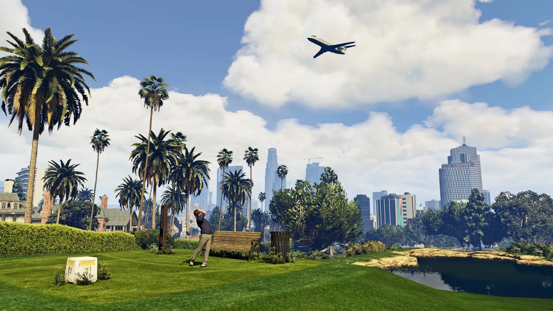 A golfer tees off on a green lined with palm trees, with the Los Santos skyline and a passing jet beyond