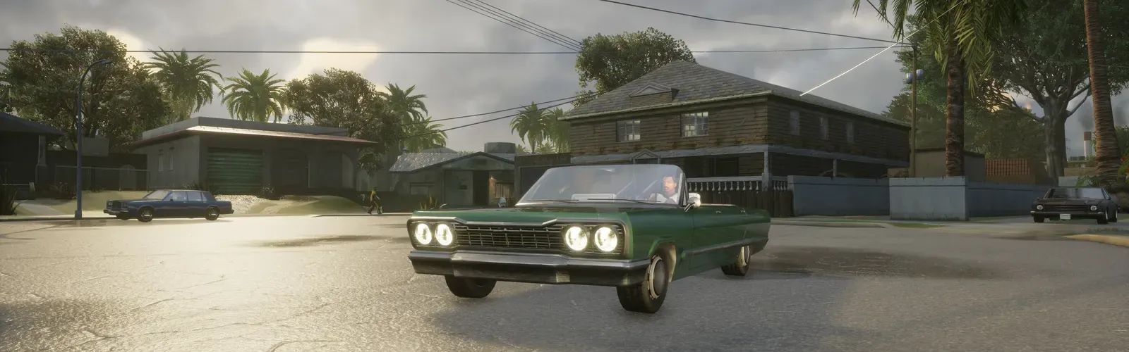 Definitive Edition: a green convertible lowrider rolls through the Grove Street cul-de-sac under a cloudy sky, palm trees and the Johnson house behind it