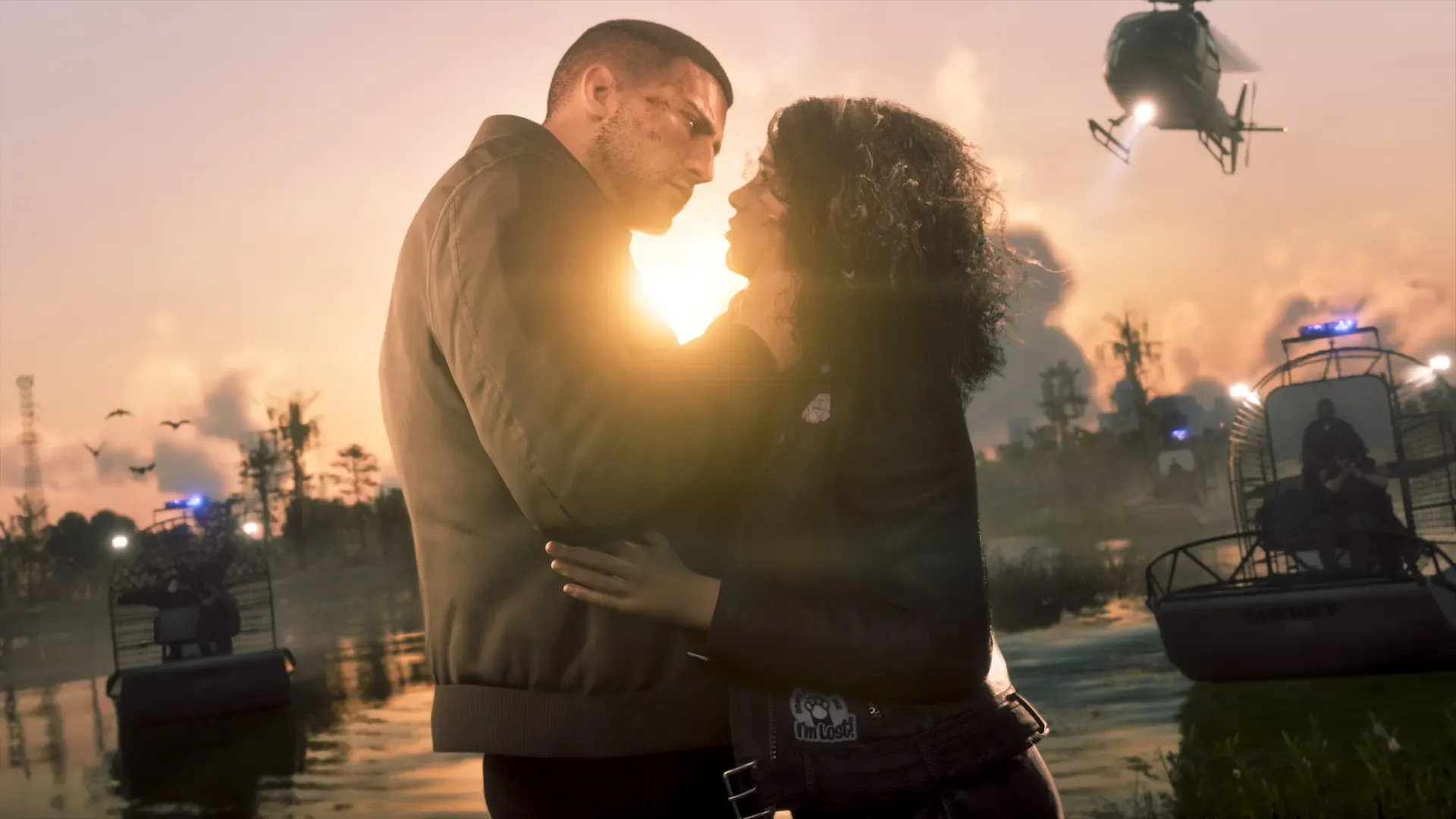 Jason and Lucia embrace at sunset beside airboats, with a police helicopter overhead.