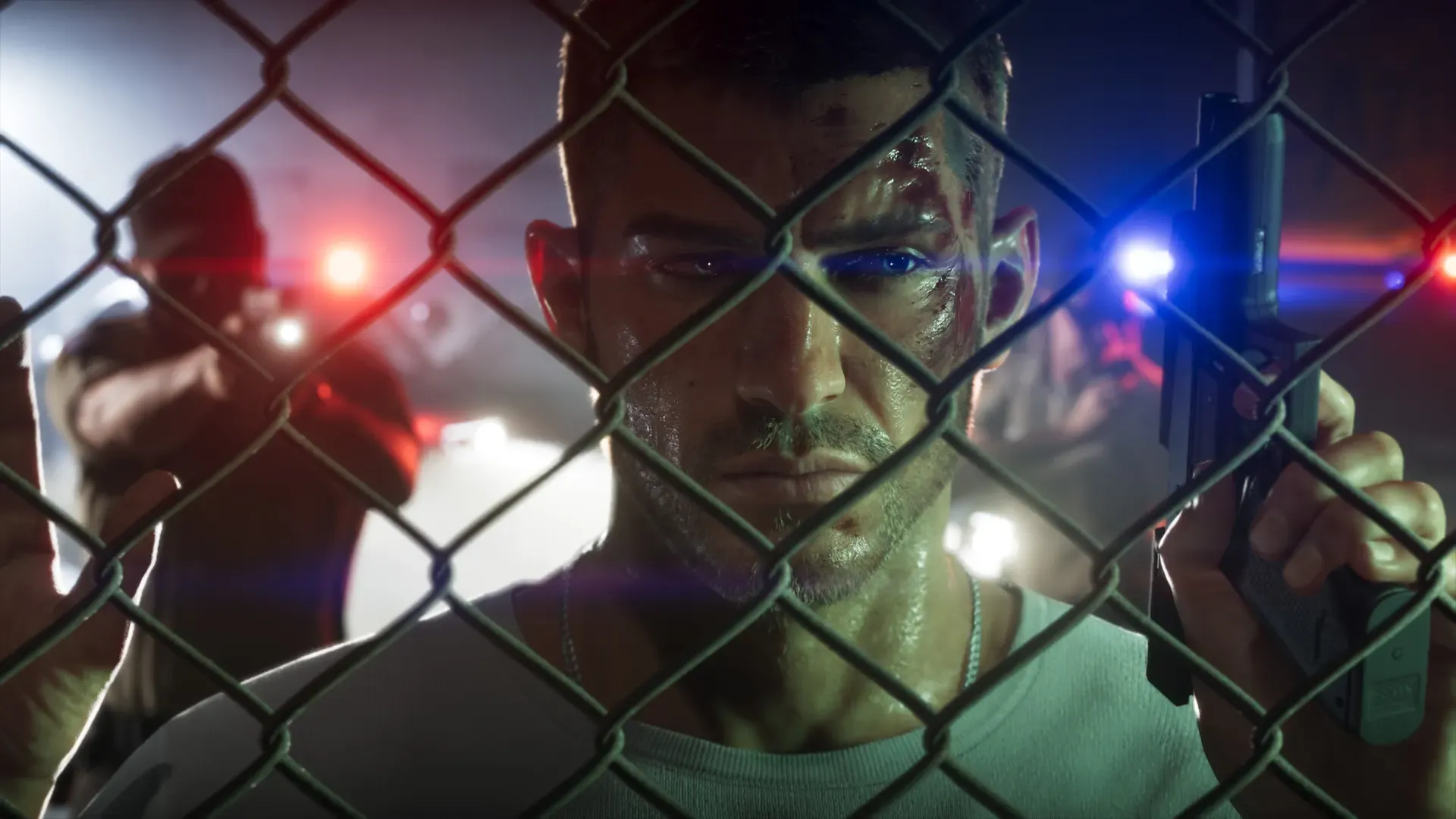 Jason holding a pistol behind a chain-link fence as police lights flash behind him.