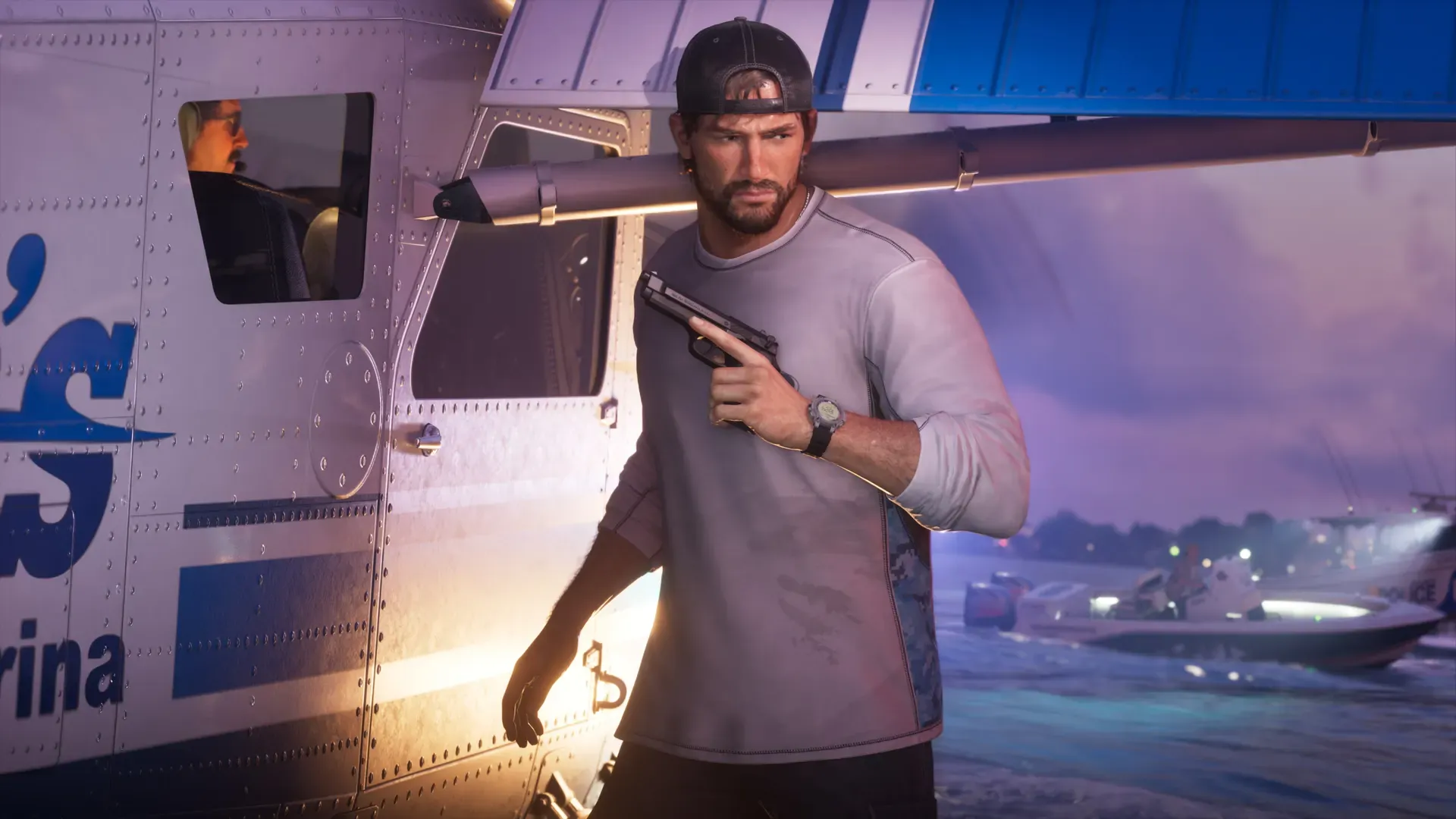 Jason holding a pistol beside a parked seaplane on a dock at dusk.