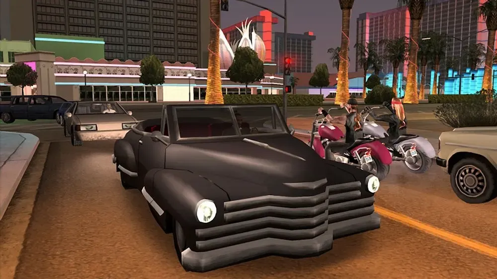 Original game (Xbox 360 release): a black vintage convertible and two bikers wait at a red light on a casino lined street at dusk