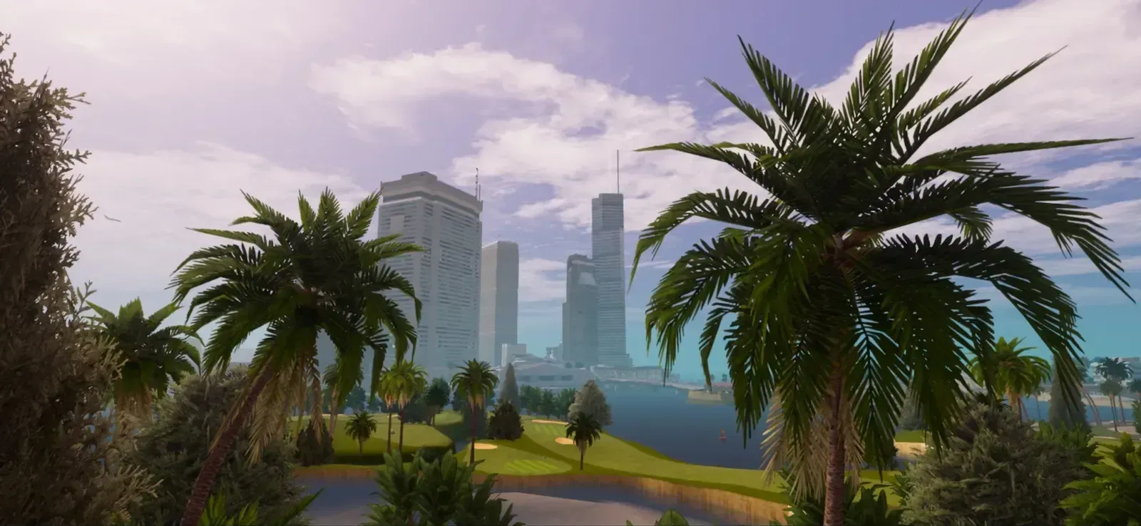 Palm trees frame a view across golf course greens and water to tall office towers on a sunny day