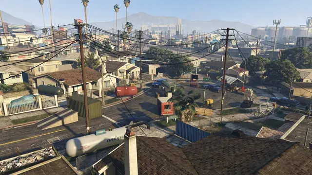 Aerial view of a sunny Los Santos neighborhood of small houses, power lines and palm trees
