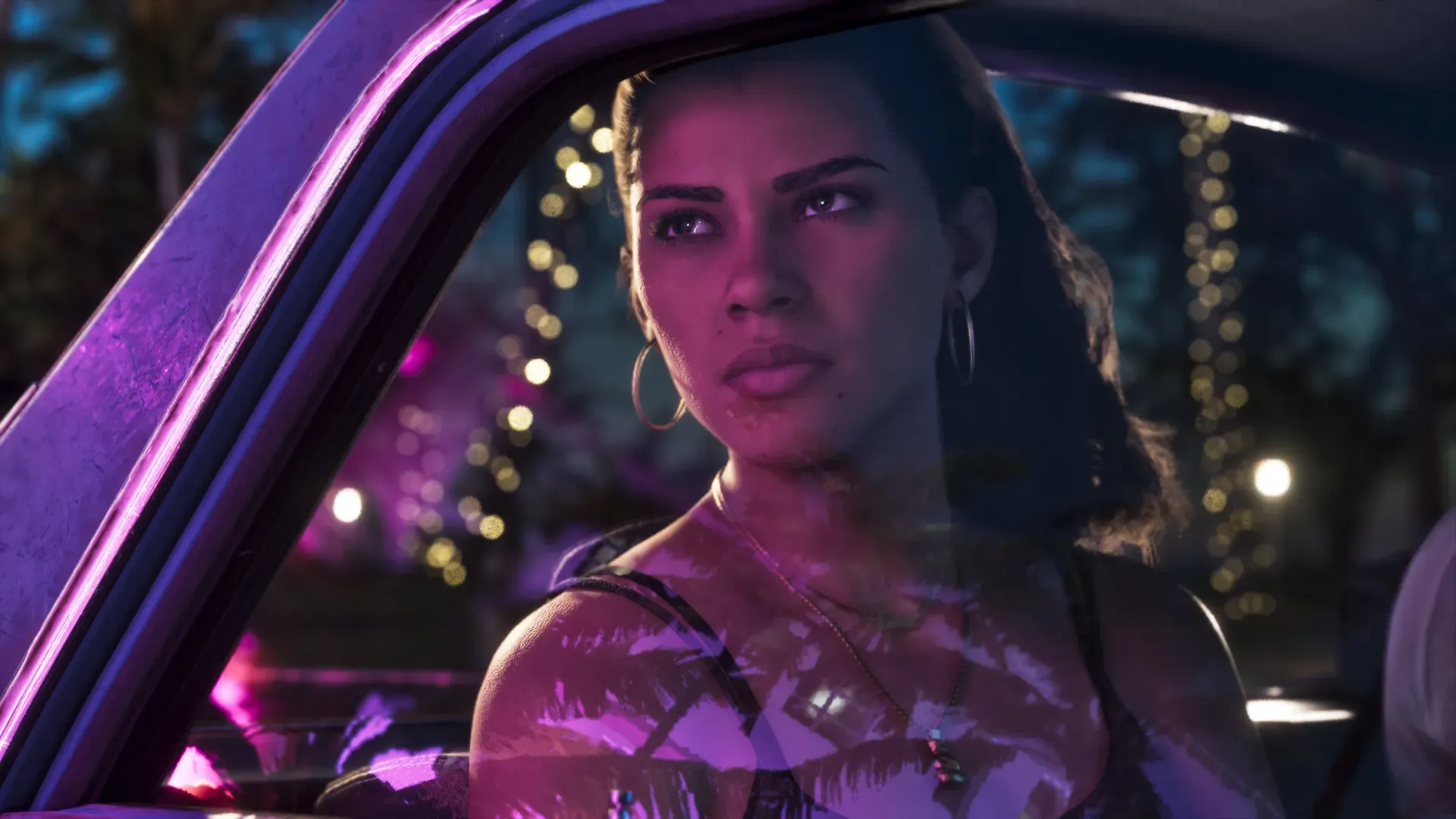 Lucia sitting in a car at night, lit by purple neon light.