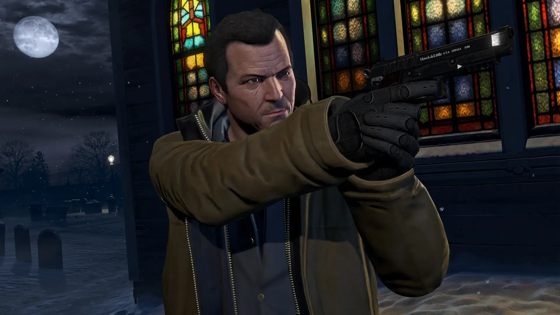 Michael aims a pistol by a church with stained glass windows and gravestones under a full moon