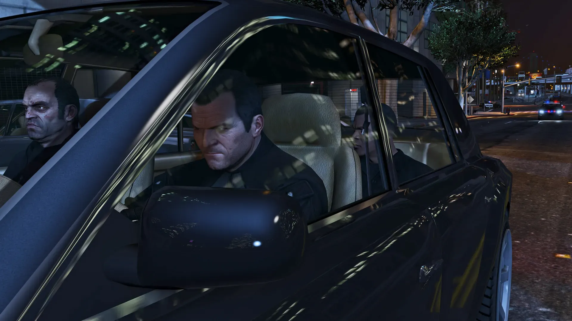 Michael drives a dark car at night while Trevor rides in the passenger seat
