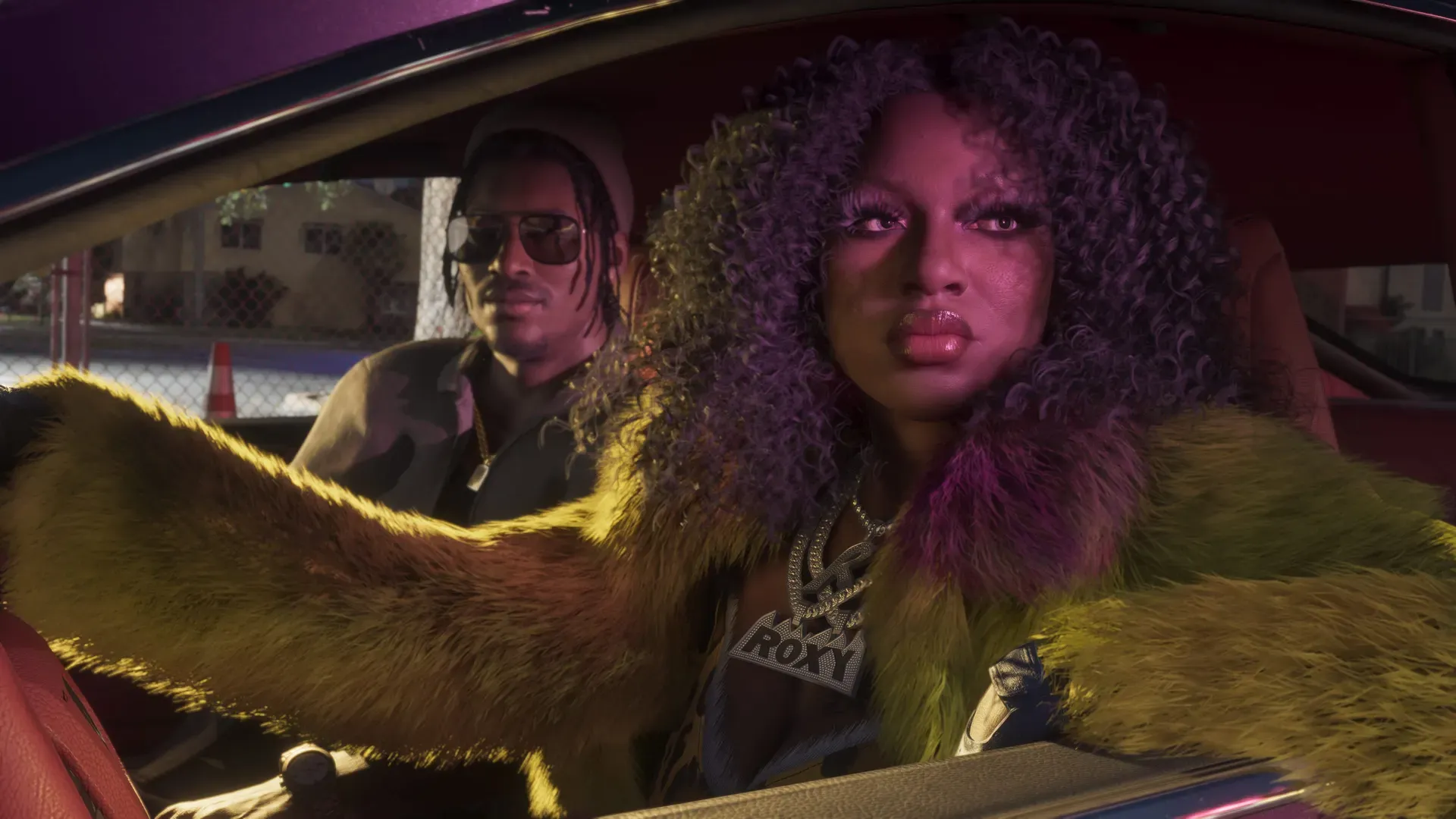 Roxy of the Real Dimez sitting behind the wheel of the car looking out the window. Dre'Quan sits next to her in the passenger seat looking out the driver's side window.