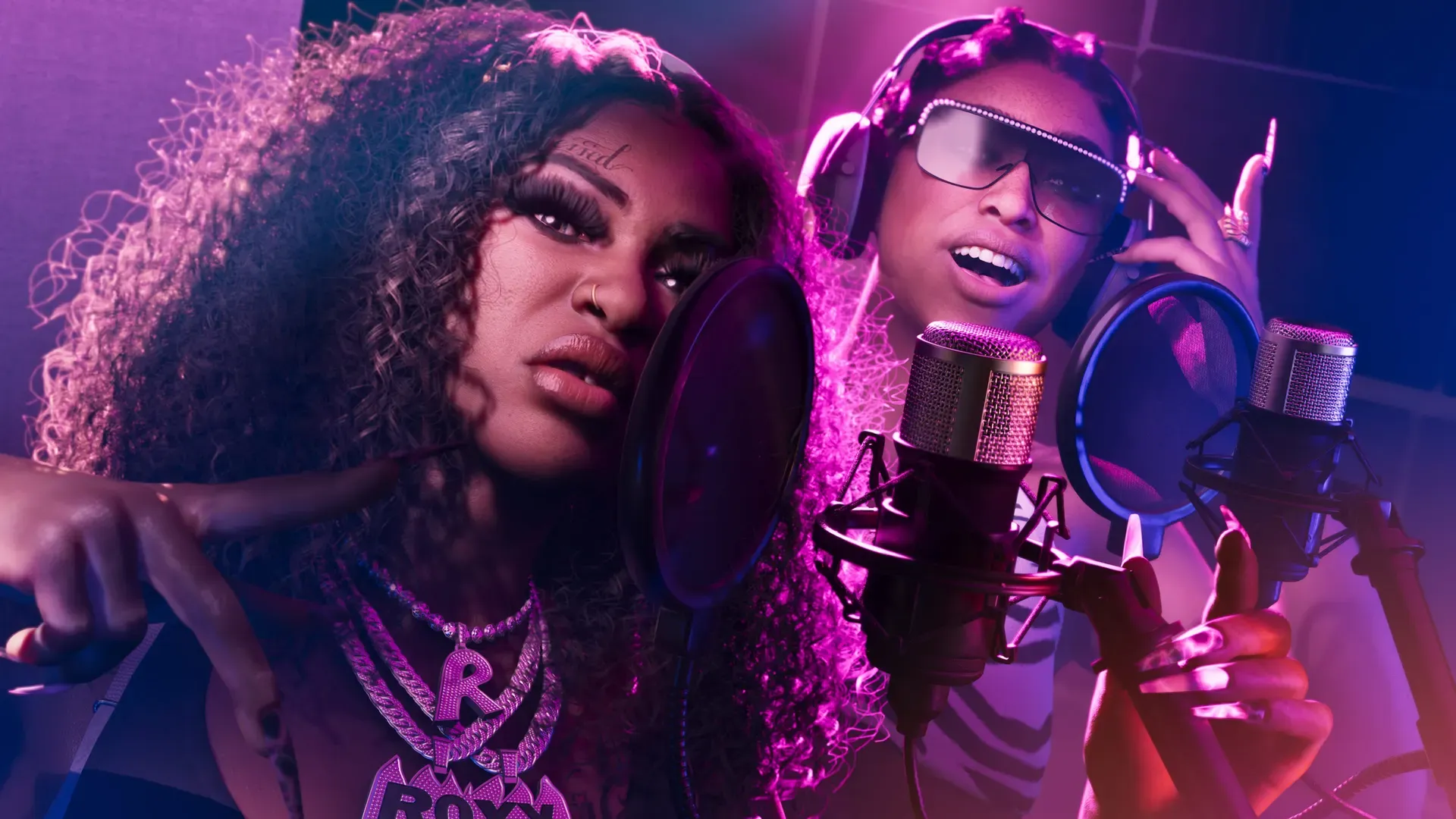 The Real Dimez speaking into microphones in a recording studio.