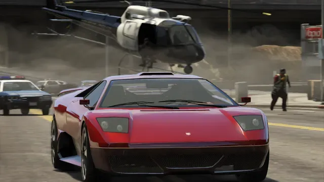 A red supercar speeds down a city street ahead of police cars, with a police helicopter low overhead