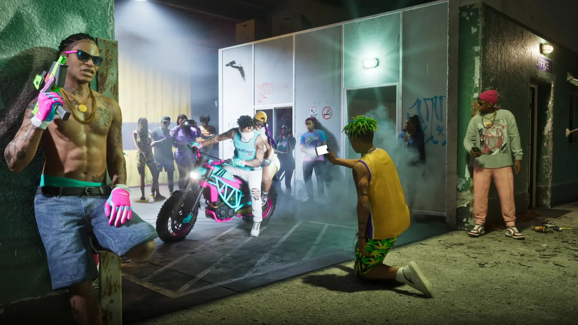 A group gathered outside a store at night, one man posing in front while others crowd around a motorcycle.
